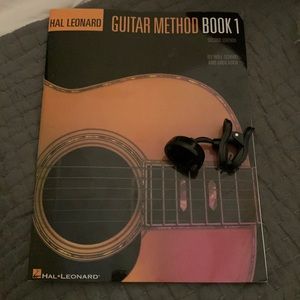 Used once Snark electric guitar tuner and Hal Leonard guitar method book 1